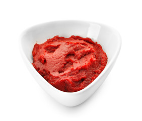 Bowl with red sauce on white background