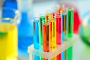 Test tubes with colorful samples in laboratory, closeup