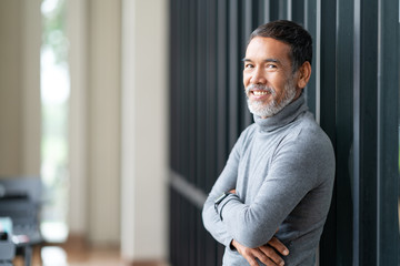 Portrait attractive mature asian man retired with stylish short beard smiling at coffee shop outdoor. Close up of old happy handsome businessman or entrepreneur in urban relax lifestyle concept.