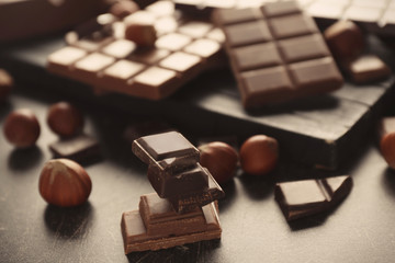 Pieces of tasty chocolate on table