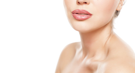Obraz na płótnie Canvas beautiful female lips with lip gloss and nacked shoulders on white background