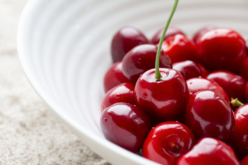a lot of ripe red fresh cherries in a bowl