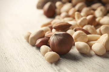Different nuts on wooden table, closeup