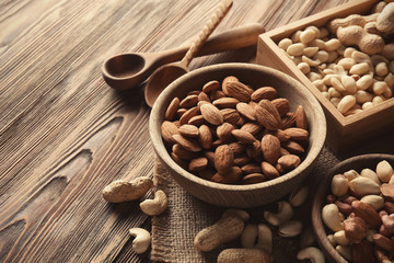 Composition with different nuts on wooden background