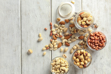 Composition with different nuts on wooden background
