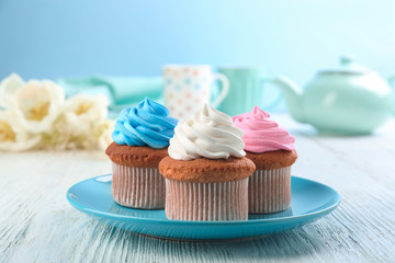 Plate with tasty cupcakes on table. Mother's Day celebration