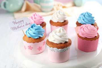 Tasty cupcakes and topper pick with words HAPPY MOTHER'S DAY on stand