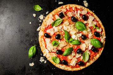 Traditional italian pizza on dark table