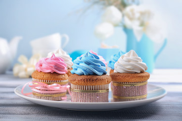 Plate with tasty cupcakes on table. Mother's Day celebration