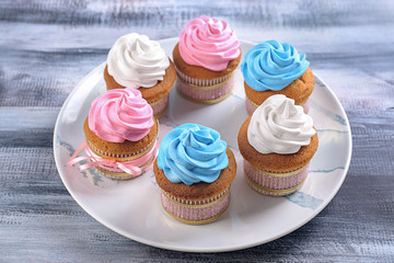 Plate with tasty cupcakes on table. Mother's Day celebration