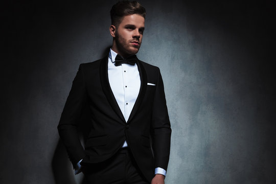 portrait of relaxed elegant man in tuxedo looking to side