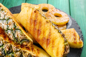 Grilled pineapple slices on table, closeup
