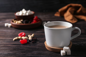 Obraz na płótnie Canvas Cup of aromatic tea with milk on table