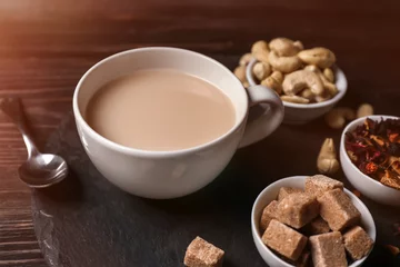 Fotobehang Cup of aromatic tea with milk on slate plate © Pixel-Shot