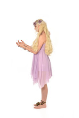full length portrait of pretty blonde girl wearing purple fairy dress. standing pose, isolated on white studio background.