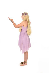 full length portrait of pretty blonde girl wearing purple fairy dress. standing pose, isolated on white studio background.