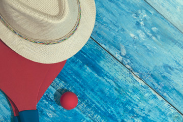 Equipment for playing beach tennis on the blue wooden background