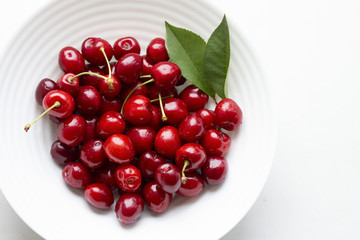 in a bowl there are many ripe juicy red cherries