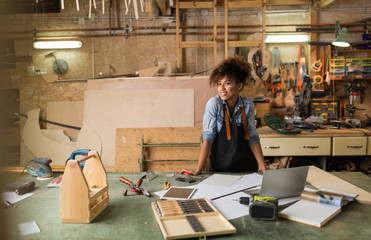 Afro american woman craftswoman working in her workshop

