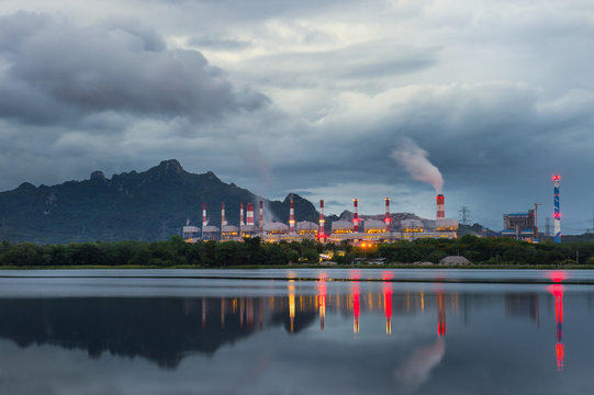 Industrial power plant with smokestack near the river