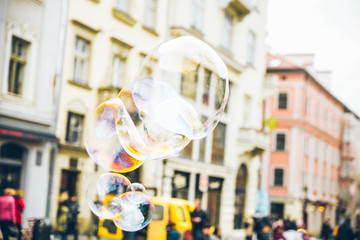 soap bubbles in the center of old european city. having fun