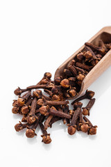 fragrant cloves on a white acrylic background