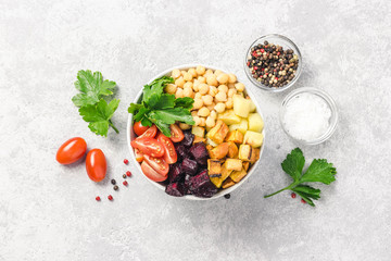 Roasted root vegetables and chickpeas buddha bowl. Top view, space for text.