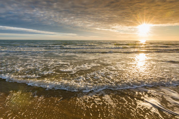 Sea surf at sunset