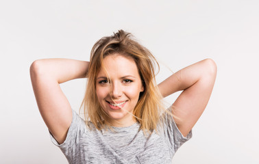 Portrait of a young beautiful woman in studio on a white background.