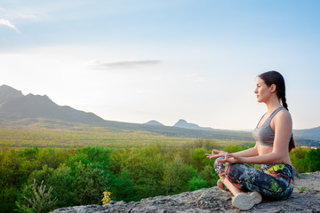 Fototapeta na wymiar Young girl doing yoga outdoor