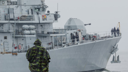 BRITISH FRIGATE - The man from breakwater is watching the outgoing warship © Wojciech Wrzesień