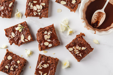 Pieces of vegan sweet potato brownie on white background, top view. Healthy vegan food concept.