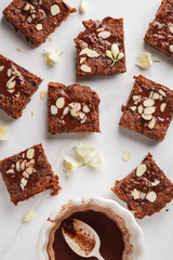 Pieces of vegan sweet potato brownie on white background, top view. Healthy vegan food concept.