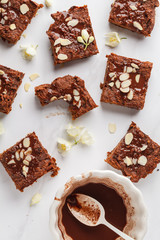 Pieces of vegan sweet potato brownie on white background, top view. Healthy vegan food concept.