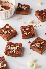 Pieces of vegan sweet potato brownie on white table. Healthy vegan food concept.