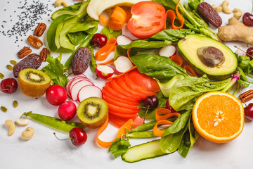Raw fresh vegetables, fruits, berries, nuts on a white background. Healthy food background. Healthy vegan food concept.