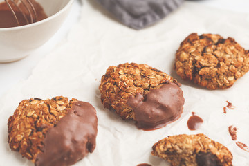 Vegan oatmeal cookies with chocolate on a white background. Food blog style concept.