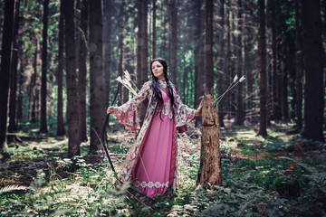 female elf with bow in a magic forest
