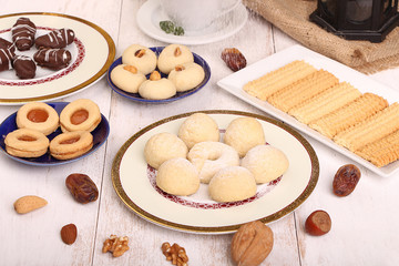 Collection of Eid El Fitr kahk and biscuits - Pouring sugar over the cookies of El Fitr Islamic Feast