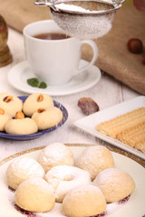 Collection of Eid El Fitr kahk and biscuits - Pouring sugar over the cookies of El Fitr Islamic Feast