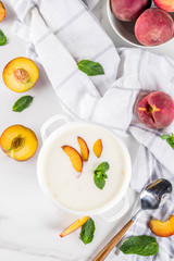 Sweet creamy peach soup, vegan summer food, white marble background copy space