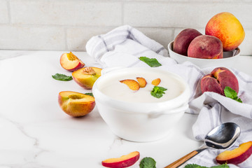 Sweet creamy peach soup, vegan summer food, white marble background copy space
