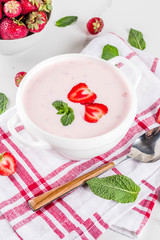 Sweet creamy strawberry soup, vegan summer food, white marble background copy space