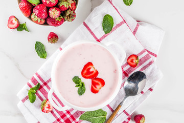 Sweet creamy strawberry soup, vegan summer food, white marble background copy space