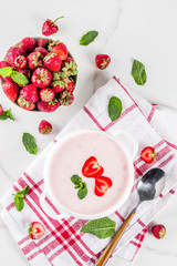 Sweet creamy strawberry soup, vegan summer food, white marble background copy space