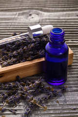 Lavender essential oil on a wooden background