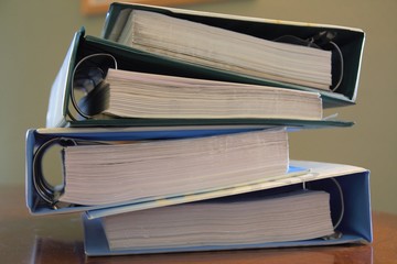 Pile of old ring binders containing paper documentation