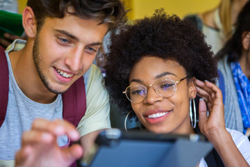 Students looking at digital tablet together