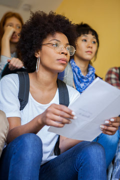College students sitting in stairwell