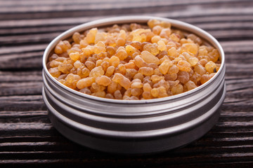 frankincense essential oil on a wooden background